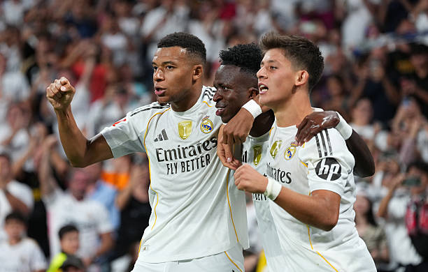 Vinicius Junior celebrates scoring his team's second goal with Kylian Mbappe and Arda Gueler (Photo by Angel Martinez/Getty Images)