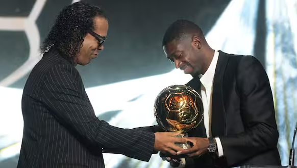 Ballon d'Or 2025 winner Ousmane Dembele receives the trophy from Ronaldinho (Credit: Ballon d’Or via X)