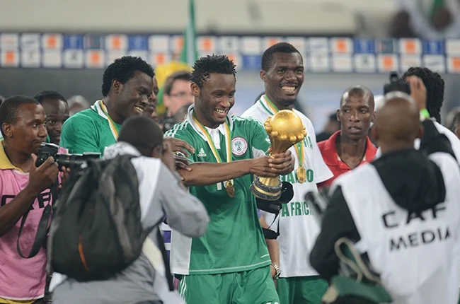 Former Super Eagles player Mikel Obi with the Afcon trophy after 2013 triumph (Photo Credit: CAF website)