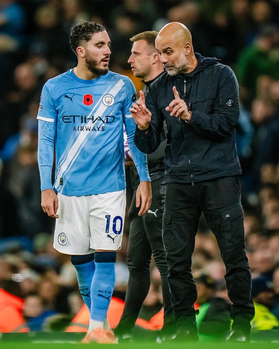 Ryan Cherki and Pep Guardiola (Photo Credit: Manchester City via X)