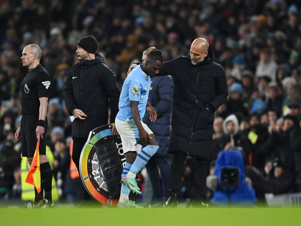 Jeremy Doku and Pep Guardiola (Photo Credit: Manchester City website)