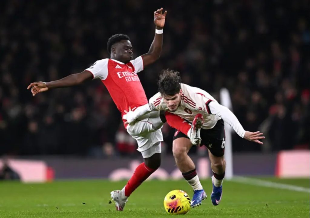 Bukayo Saka with a mistimed tackle. (Photo Credit: Arsenal Media).