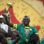Saido Mane lifting the AFCON title. (Photo Credit: CAF Media).