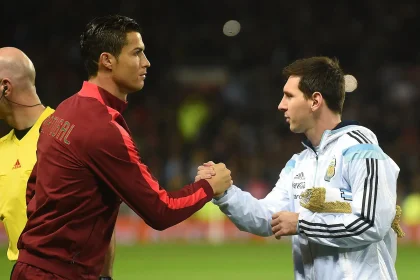 Cristiano Ronaldo and Lionel Messi shaking hands - Photo Credit : Softfootball Media