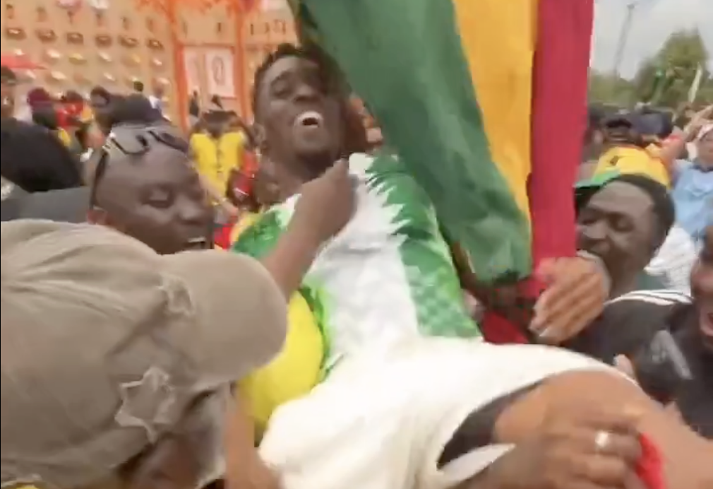 Ghana Fans Celebrate Joyfully With Nigeria Supporter After England Draw at 2026 World Cup - Photo Credit : Leagues Reporter, X