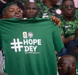 Nigerian Fan with Tshirt branded Hope Day we must Qualify ahead of 2026 world Cup - Photo credit : BBC